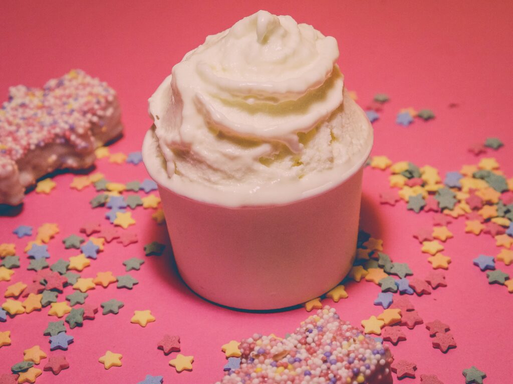 Close-up Of Dessert With Colorful Sprinkles On Table